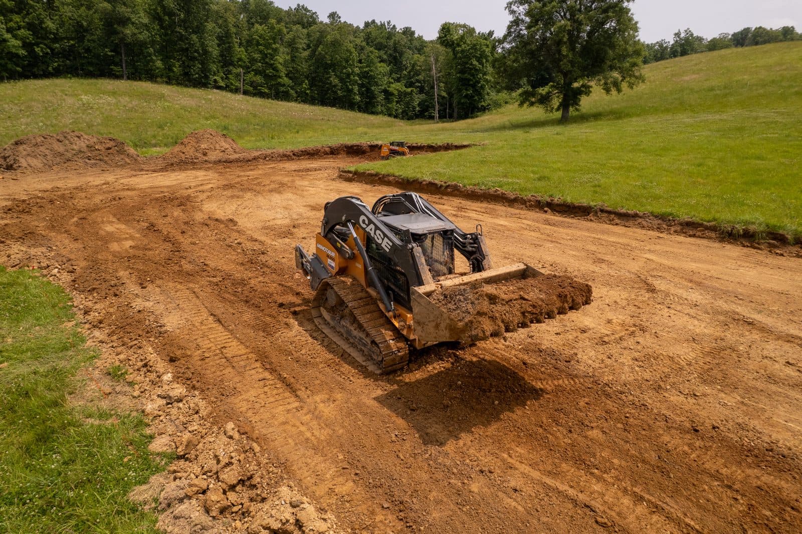 Roth Dirt Worx skid steer grading a building pad in Greenville, MO
