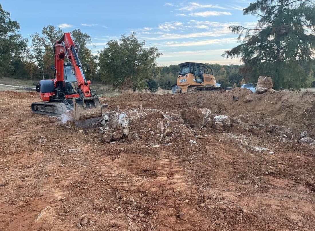 Excavator digging in a rock and soil pit